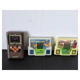 Three vintage electronic handheld games, battery