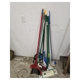 Lot of assorted cleaning tools - brooms, mops,