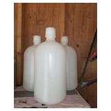 Three heavy duty plastic 2 gallon water jugs