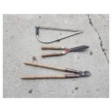 Hedge trimmers and hand saw.