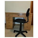 Desk and black chair on wheels