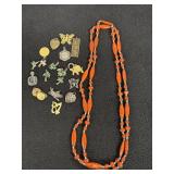 Orange and blue beaded necklace, pendants