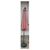 Green Umbrella Stand with Faded Red Umbrella