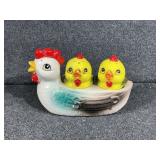 Mother hen with her two chicks, salt and pepper