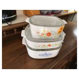 Three vintage CorningWare casserole dishes with lids
