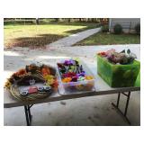 Artificial flowers and wreaths in totes
