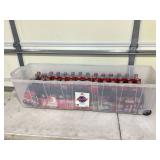 Multiple NASCAR and Santa Coca-Cola six-packs in long tote with lid
