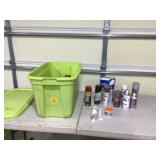 Assorted spray paint cans in container