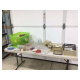 Assorted picture frames and glass pieces in tote with lid
