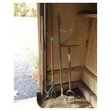 Four gardening tools leaf rakes shovel lawn aerator