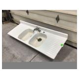 Old white farmhouse sink with porcelain enamel
