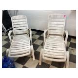 Two white plastic chairs