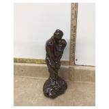 Old glazed statue of embracing couple