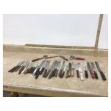 Wide variety of old knives and sharpener