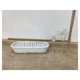Two clear glass candle holders in white basket Two clear glass candle holders in white basket