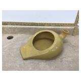 Old yellow pottery urinal
