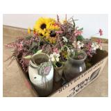 Colorful fake flowers in jars
