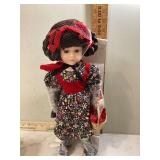 Small doll wearing red cloak