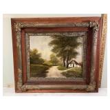 Signed oil painting in large decorative frame depicting country house