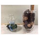 Glass vase with pinecones and candleholder
