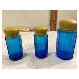 Vintage blue glass shakers with yellow lids