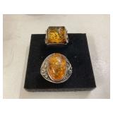 Two silver rings with 925 markings one with a brown stone in size
