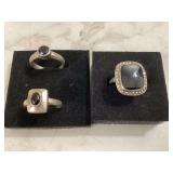 Three silver rings with black stones size 5 7 and