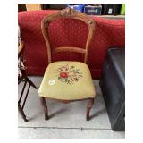 Vintage wooden chair with floral stitched upholstery
