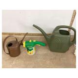 2 watering cans 1 copper 1 plastic
