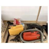 Two vintage Eureka canister vacuums with attachments