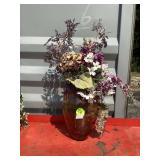 Tall glass vase with fake flowers