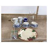 Assorted kitchen items including cups mugs plate vase
