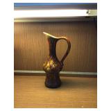 A glazed decanter pitcher with a dripping design
