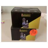 Two Buddha incense holders with incense