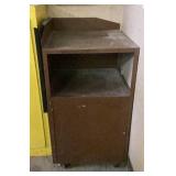 Brown metal storage cabinet on casters,