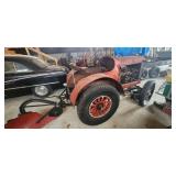 Antique Doodlebug tractor with plow