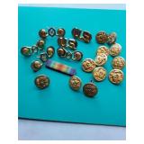 Military pins and uniform buttons.