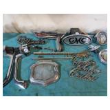 Assorted car parts and badges.