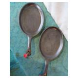 Oval cast iron skillets, (2) unmarked.