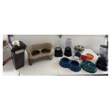 Assorted dog bowls, food container, water