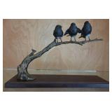 3 Black Birds Perched On Brass Branch