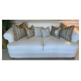 White Leather Sofa With Decorative Throw Pillows