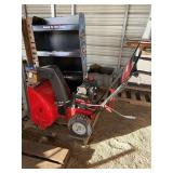 Snow blower by MTD & NASCAR stand shelving, bldg:green