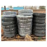 Numerous new rolls of 1" irrigation pipe