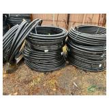 Numerous rolls of 1.5" irrigation pipe