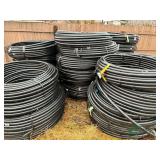 Numerous rolls of new 1.25" irrigation pipe