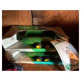 (2) John Deere push spreaders in boxes