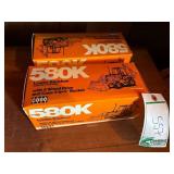 (2) 580K Backhoes in boxes