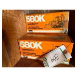 (3) 580K Backhoes in boxes