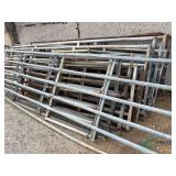 Pile of Livestock Gates, most are damaged or missing rails